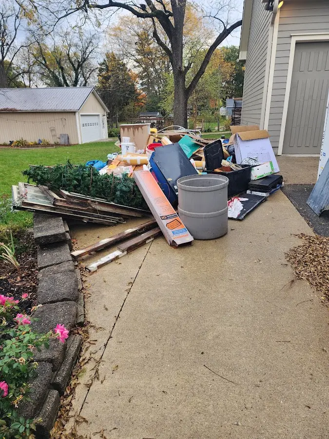 Dumpster being loaded with debris for 12 Yard Dumpster Rental in Richfield